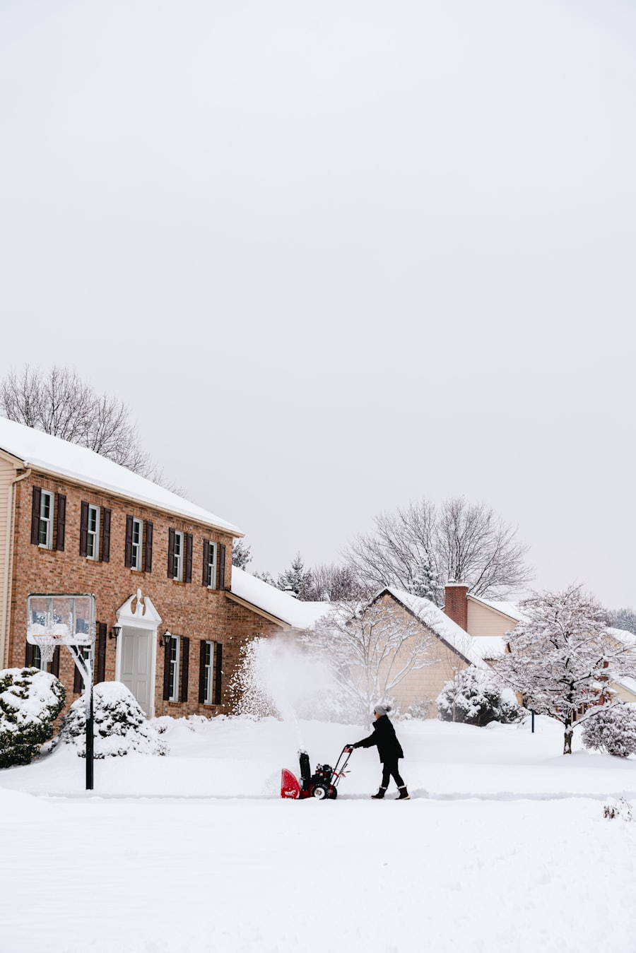 Snow blowing a residential driveway in Ramsey, Minnesota
